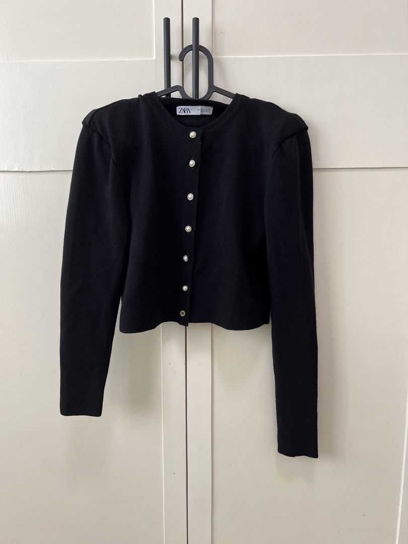 Zara Black Buttoned Cardigan (Category: Coats, Jackets and Outerwear) located in Santa Cruz. Submitted by beautsbees (Listing ID 1424481441, Image 1). Description: - Zara Black Cardigan - Size XS - Features elegant pearl-like buttons - Classic black color - Perfect for layering - Has missing pearl on the last button - uneven sleeve length.