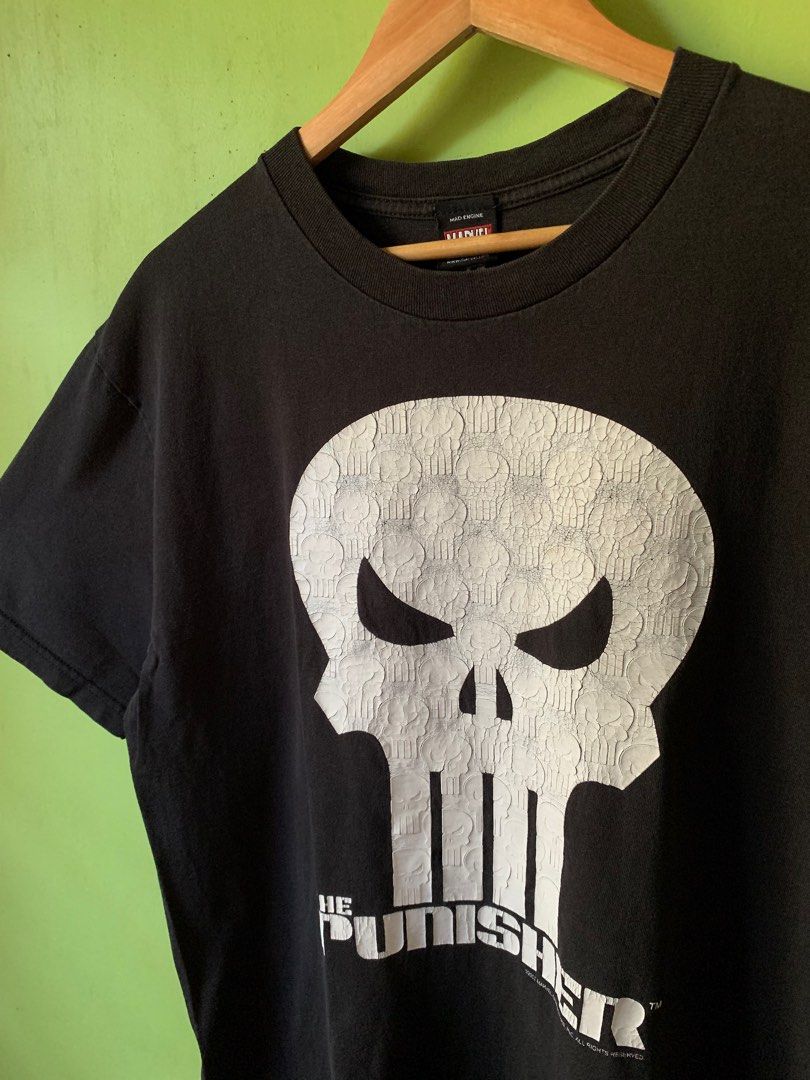 2002 The Punisher tee (Category: Tshirts & Polo Shirts ) located in Cagayan de Oro. Submitted by premium_thrifts (Listing ID 1429193772, Image 2). Description: Black colorway. Good condition. Issues: has fades, heavy crackprint (adds character fr), and pinhole on the collar - MEASUREMENTS: L29" x W21.5" 20" (shoulder to shoulder) 8.6" (sleeve length) Fits Large Add shipping fee (via JRS or J&T).