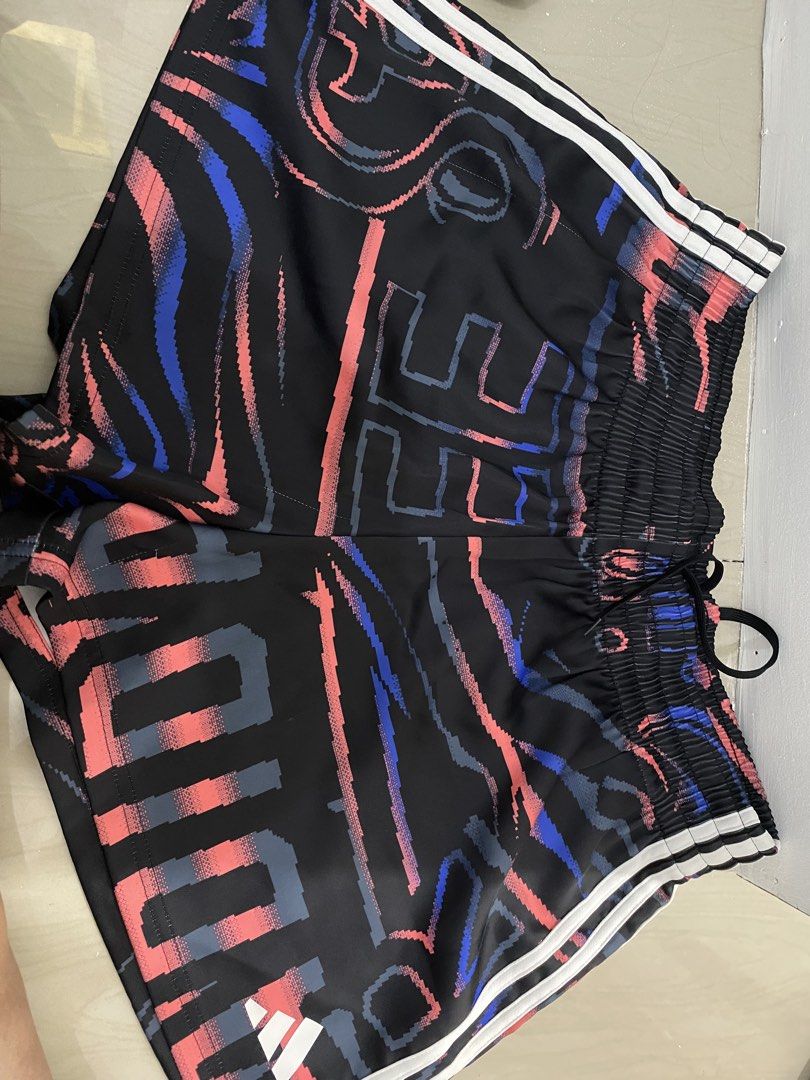 Adidas Printed Shorts - Size L (Category: Shorts) located in Rizal. Submitted by decluttermommaa (Listing ID 1429220084, Image 1). Description: Adidas shorts with a unique printed design. Features the Adidas logo and the iconic three stripes. The shorts have an elastic waistband with a drawstring. Size L. Made in Cambodia. The shorts have a mesh lining..
