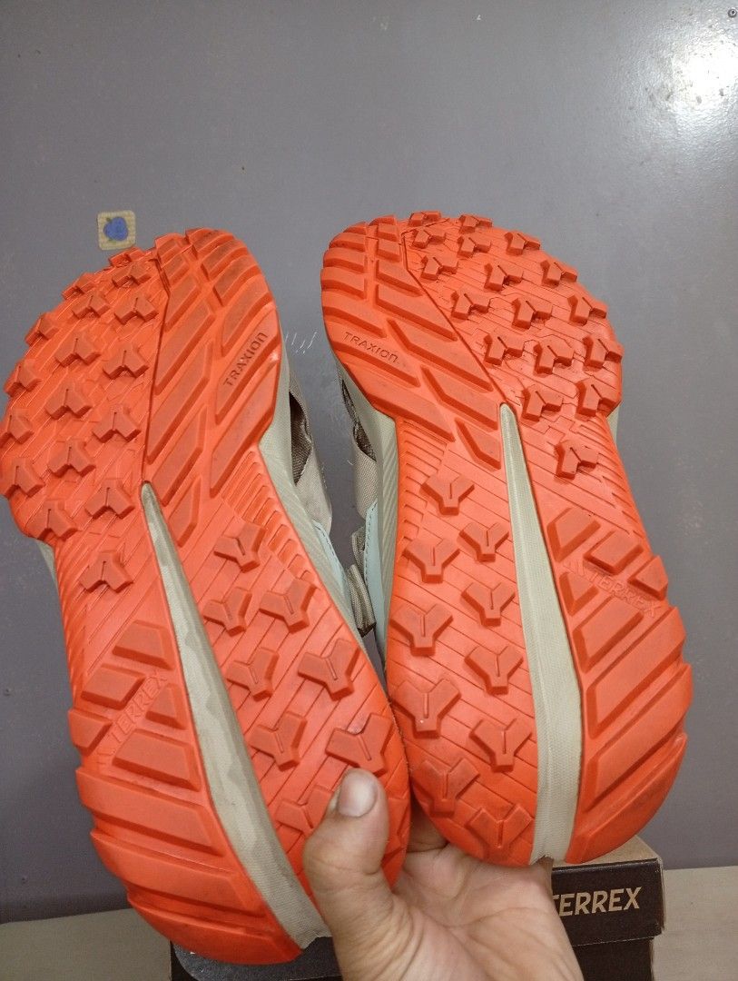 Adidas Terrex Hydroterra AT Sandals (Category: Flats & Sandals) located in Makati City. Submitted by vians2002 (Listing ID 1429168884, Image 3). Description: Adidas Terrex Hydroterra AT sandals. Features a beige and orange color scheme. The sandals have adjustable straps and a rugged outsole for traction. The size is US 6, UK 6, and EUR 39. The original price is PHP 5,300.00. Comes with the original box..