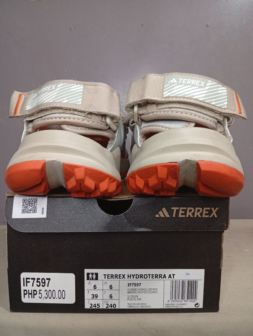 Adidas Terrex Hydroterra AT Sandals (Category: Flats & Sandals) located in Makati City. Submitted by vians2002 (Listing ID 1429168884, Image 1). Description: Adidas Terrex Hydroterra AT sandals. Features a beige and orange color scheme. The sandals have adjustable straps and a rugged outsole for traction. The size is US 6, UK 6, and EUR 39. The original price is PHP 5,300.00. Comes with the original box..