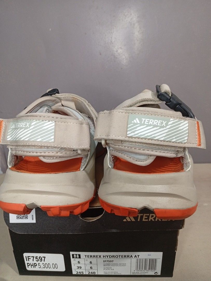 Adidas Terrex Hydroterra AT Sandals (Category: Flats & Sandals) located in Makati City. Submitted by vians2002 (Listing ID 1429168884, Image 2). Description: Adidas Terrex Hydroterra AT sandals. Features a beige and orange color scheme. The sandals have adjustable straps and a rugged outsole for traction. The size is US 6, UK 6, and EUR 39. The original price is PHP 5,300.00. Comes with the original box..