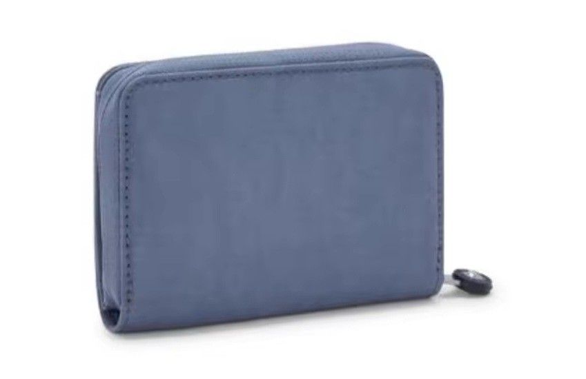 Authentic Kipling Money Love Wallet Ocean Blue (Category: Wallets & Card holders) located in Davao. Submitted by jilly07 (Listing ID 1429334852, Image 3). Description: Kipling wallet features a zip-around closure and multiple compartments for cards and cash. It has a clear ID window and a snap closure. The wallet is made of a durable, textured material and includes the Kipling logo. Used only ONCE. GOOD as NEW. In EXCELLENT condition. Comes with 