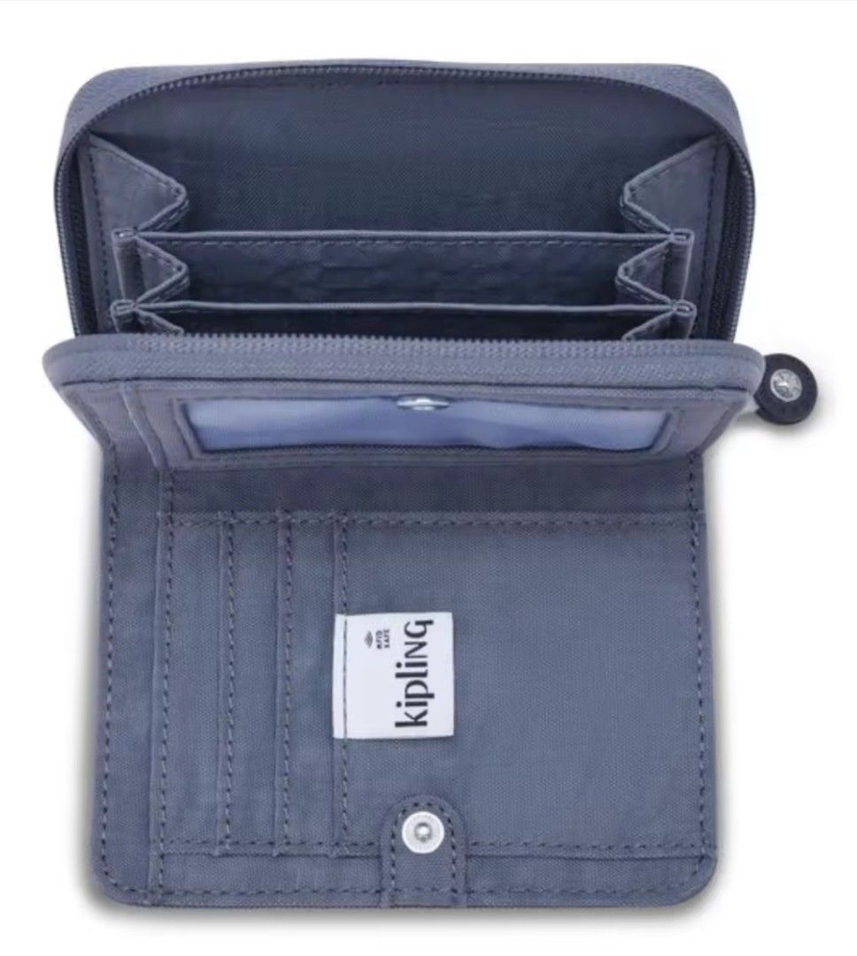 Authentic Kipling Money Love Wallet Ocean Blue (Category: Wallets & Card holders) located in Davao. Submitted by jilly07 (Listing ID 1429334852, Image 2). Description: Kipling wallet features a zip-around closure and multiple compartments for cards and cash. It has a clear ID window and a snap closure. The wallet is made of a durable, textured material and includes the Kipling logo. Used only ONCE. GOOD as NEW. In EXCELLENT condition. Comes with 