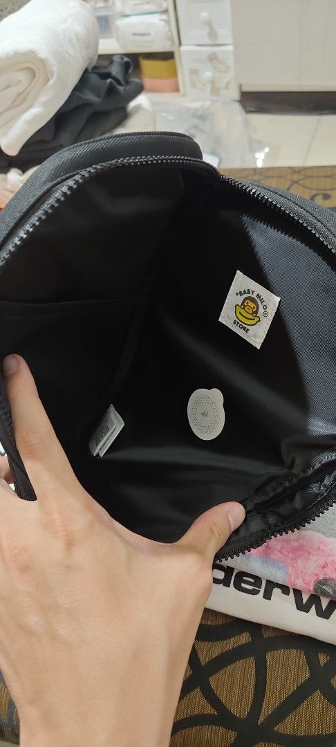 BAPE baby milo Sling cross bag (Category: Luxury Bags & Wallets) located in Manila. Submitted by sik2find (Listing ID 1429272518, Image 2). Description: BRANDNEW AUTHENTIC CROSS BODY BAG Black BAPE shoulder bag featuring the iconic ape head design. Includes a detachable banana charm and a branded strap. The bag has a zippered main compartment and an interior pocket. The bag is new with tags..