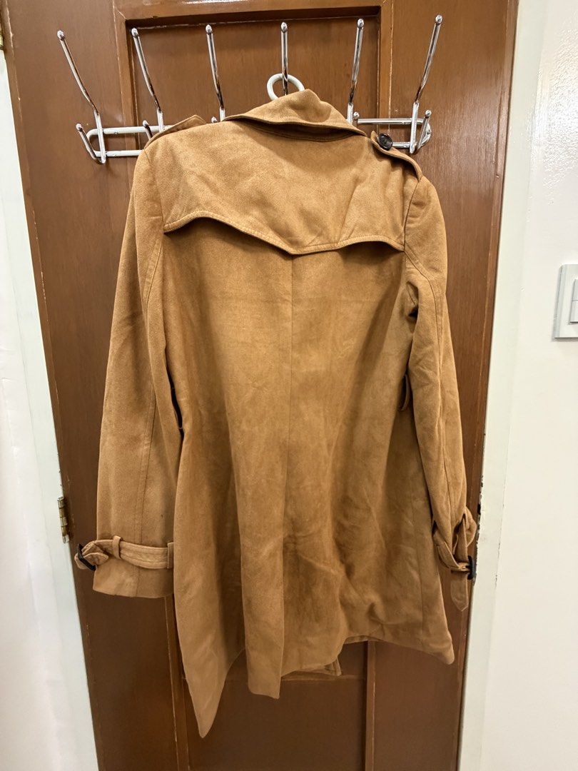Brown Trench Coat (Category: Coats, Jackets and Outerwear) located in Angeles City. Submitted by exate (Listing ID 1429177134, Image 2). Description: - Stylish brown trench coat - Double-breasted with black buttons - Features a collar and adjustable cuffs - Classic silhouette - Made of a suede-like material - Perfect for adding elegance Size Medium but could fit up to Large .
