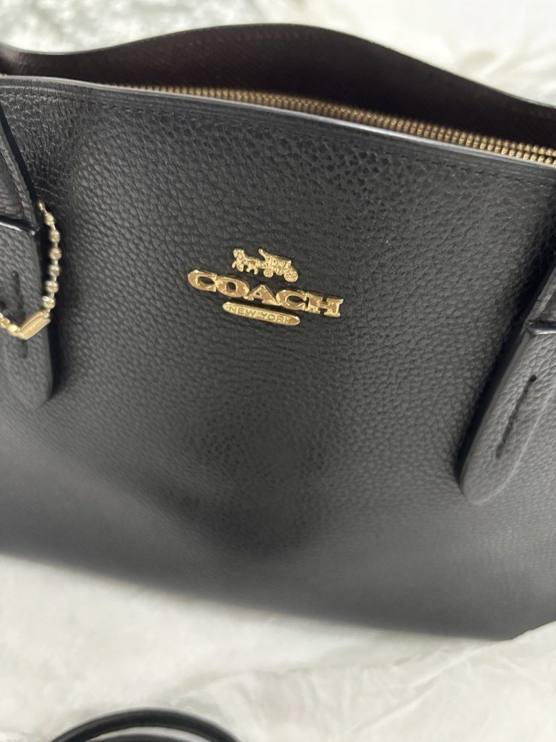 Coach Black Leather Handbag with Shoulder Strap (Category: Luxury Bags & Wallets) located in Quezon City. Submitted by pamelajoyc07797 (Listing ID 1429232040, Image 3). Description: Black Coach handbag with a top handle and a detachable shoulder strap. gold-tone Coach logo on the front. Includes a matching black shoulder strap with gold hardware. The interior color is brown. •crossgrain/pebbled leather •top zip closure •double handles. Detachable