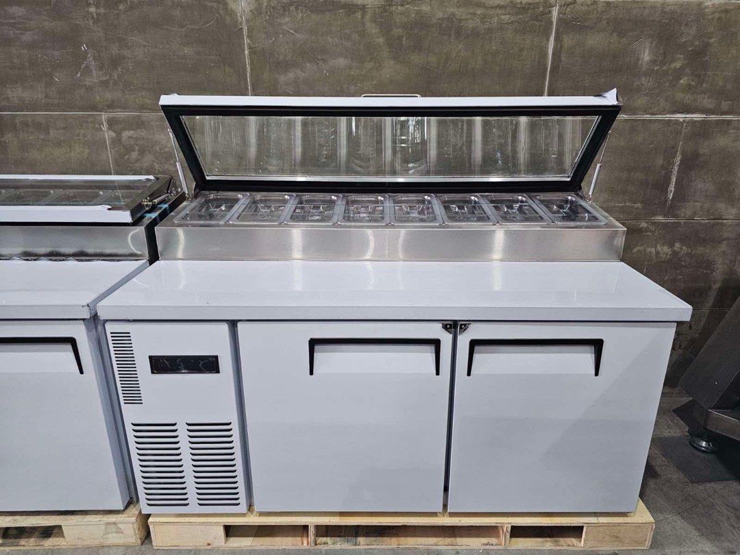 Commercial Pizza Prep Table Refrigerator (Category: Refrigerators and Freezers) located in Manila. Submitted by jackelyn_kwprofessional (Listing ID 1429293531, Image 2). Description: Brand New Available in different sizes: 120cm, 150cm and 180cm - Commercial pizza prep table refrigerator - Stainless steel exterior - Glass-top display for ingredients - Two doors - Side cooling unit - Includes food pans - Designed for commercial kitchen use 1 Year 