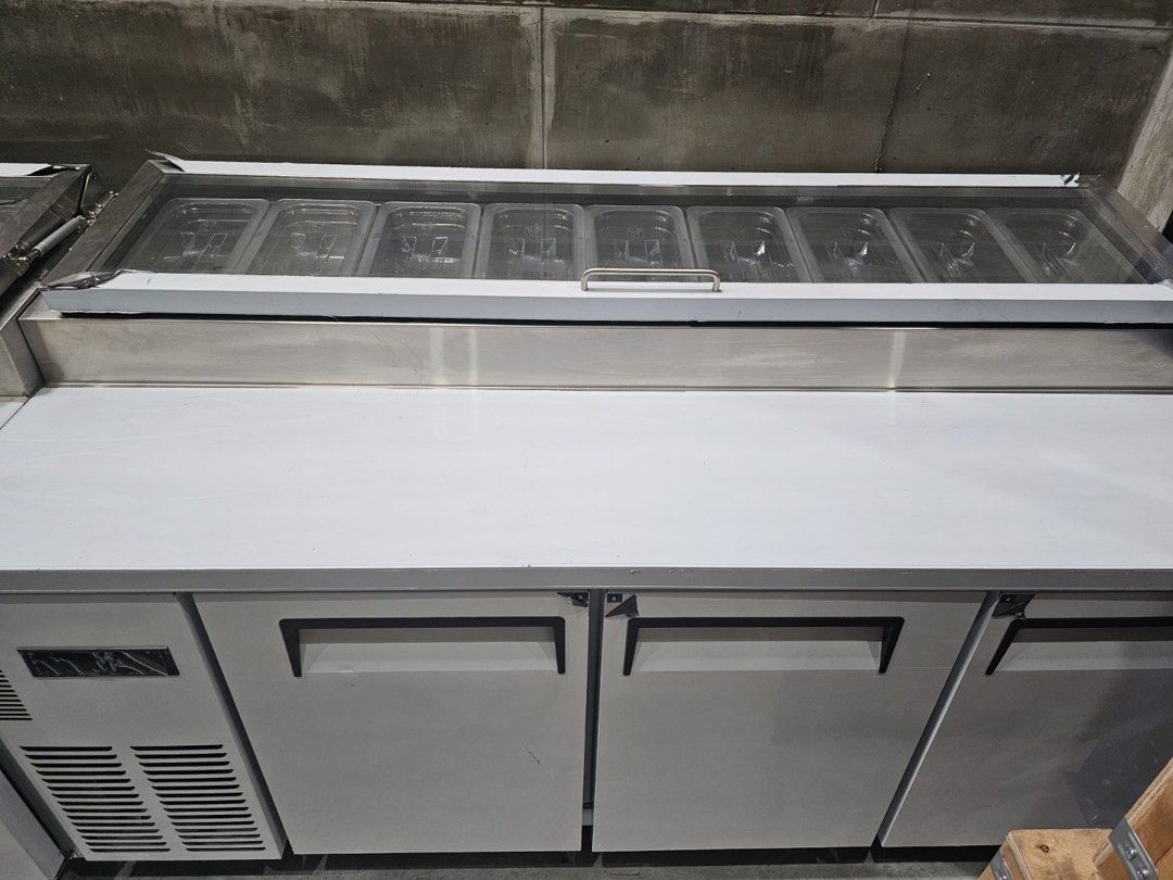 Commercial Pizza Prep Table Refrigerator (Category: Refrigerators and Freezers) located in Manila. Submitted by jackelyn_kwprofessional (Listing ID 1429293531, Image 3). Description: Brand New Available in different sizes: 120cm, 150cm and 180cm - Commercial pizza prep table refrigerator - Stainless steel exterior - Glass-top display for ingredients - Two doors - Side cooling unit - Includes food pans - Designed for commercial kitchen use 1 Year 