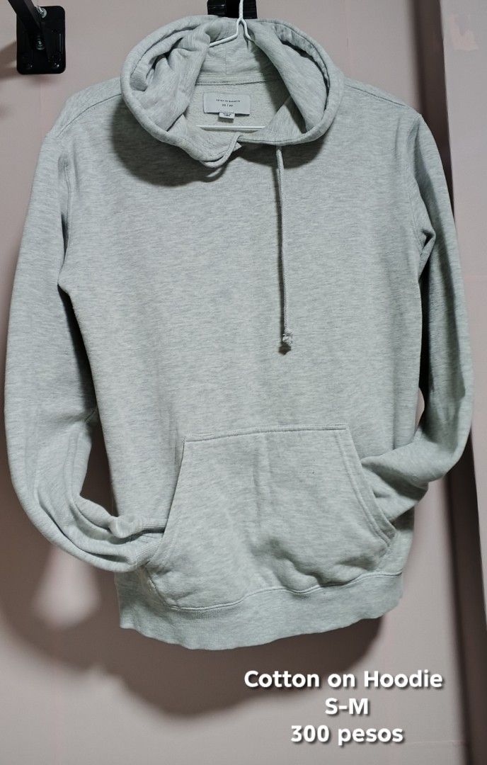Cotton On Hoodie S-M (Category: Coats, Jackets and Outerwear) located in Manila. Submitted by mightytree.ce1437 (Listing ID 1429209224, Image 1). Description: Gray Cotton On hoodie. Features a hood with a drawstring, a kangaroo pocket, and ribbed cuffs and hem. The size is S-M. Perfect for casual wear..