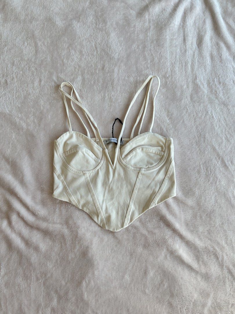 Cream Corset Top (Category: Sleeveless) located in Manila. Submitted by rayennss (Listing ID 1429271446, Image 2). Description: Cream-colored corset top with spaghetti straps. Features a V-neckline and structured bodice. Perfect for a night out or a special occasion. The material looks smooth and the design is flattering..