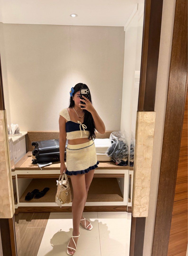 Crochet Crop Top and Skirt Set (Category: Sets or Coordinates) located in Pasig City. Submitted by abwhite (Listing ID 1429329364, Image 1). Description: - Crochet crop top and mini skirt set - Features a square neckline and tie detail on the top - Mini skirt with a ruffled hem - Elegant cream color with navy blue accents - Ideal for beach days and summer outings.