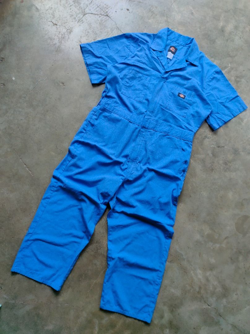 Dickies Blue Coverall Jumpsuit Workwear (Category: Coats, Jackets and Outerwear) located in Baguio. Submitted by pormado (Listing ID 1429308683, Image 2). Description: Blue Dickies coverall jumpsuit. It features short sleeves, a collared neckline, and a front button closure. There are pockets on the chest and the back. The Dickies logo is visible on the chest and the back. (ITEM NO.1) Excellent Condition Width: 21 Waist: 34 Thigh: 12 Leg Opening: