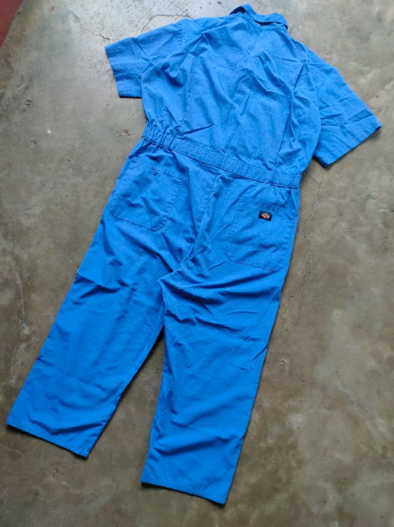 Dickies Blue Coverall Jumpsuit Workwear (Category: Coats, Jackets and Outerwear) located in Baguio. Submitted by pormado (Listing ID 1429308683, Image 3). Description: Blue Dickies coverall jumpsuit. It features short sleeves, a collared neckline, and a front button closure. There are pockets on the chest and the back. The Dickies logo is visible on the chest and the back. (ITEM NO.1) Excellent Condition Width: 21 Waist: 34 Thigh: 12 Leg Opening: