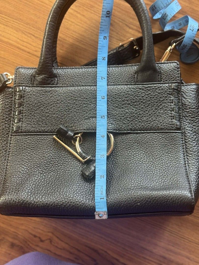 Dr. Vany Black Handbag with Shoulder Strap (Category: Luxury Bags & Wallets) located in Bacolod City. Submitted by closetxchange (Listing ID 1429228511, Image 3). Description: Black handbag with a top handle and a detachable shoulder strap. Features a gold-tone zipper and hardware. The interior has a patterned lining with the brand name. The bag has a textured exterior and a ring detail on the front. Measurements are approximately 9 inches wide a