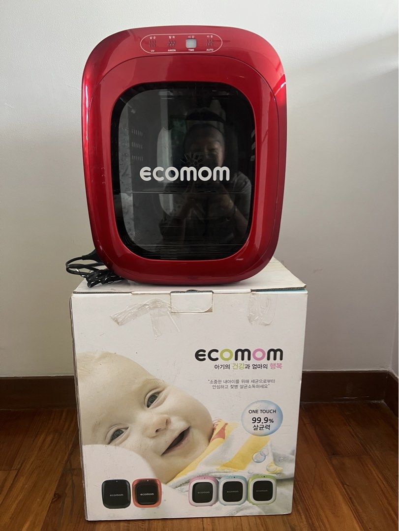 Ecomom Baby Bottle Dual UV Sterilizer BCO-100 (Category: Breastfeeding & Bottle Feeding) located in Quezon City. Submitted by liz.ty (Listing ID 1429222156, Image 1). Description: Ecomom baby bottle sterilizer with UV, anion, and auto functions. The sterilizer has a red front and a white back. It includes a rack for bottles and other items. The original box is included. The product is made in Korea. The original price was PHP 14,999.75 bought fro