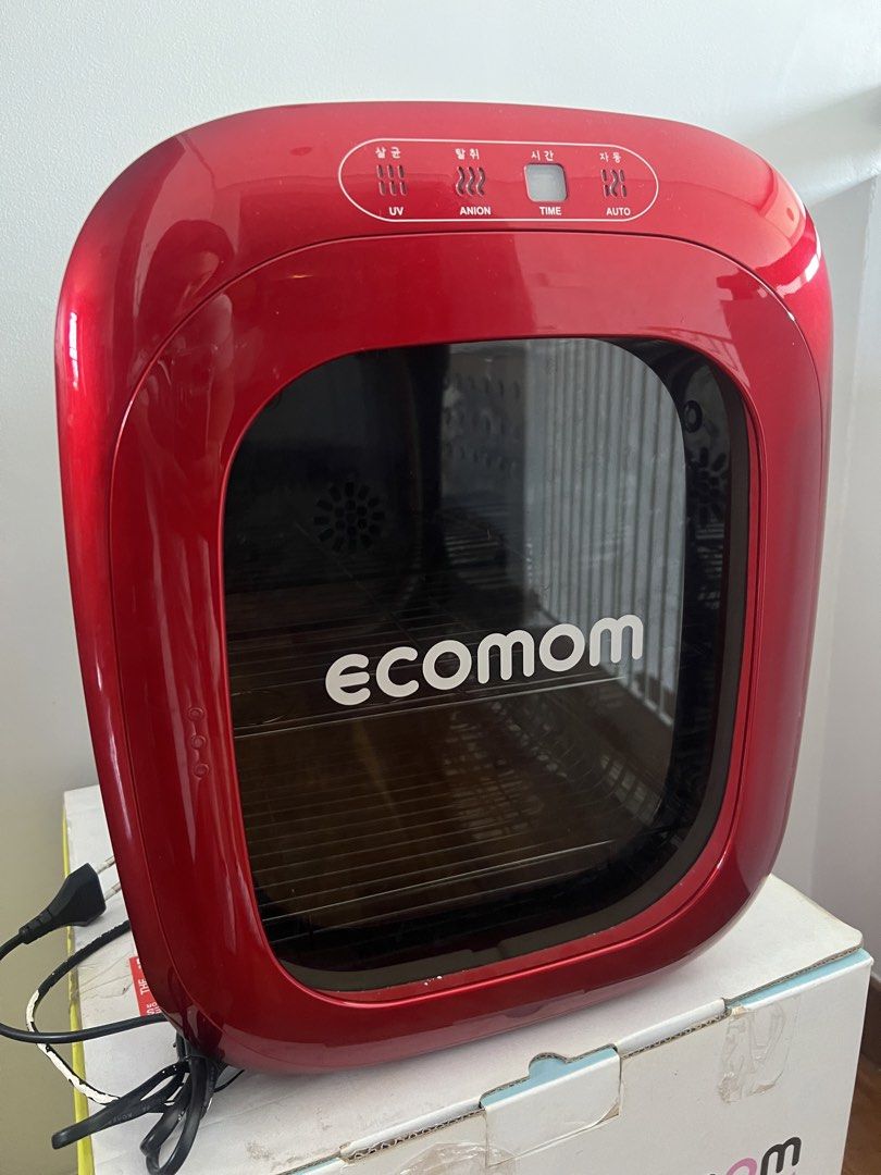 Ecomom Baby Bottle Dual UV Sterilizer BCO-100 (Category: Breastfeeding & Bottle Feeding) located in Quezon City. Submitted by liz.ty (Listing ID 1429222156, Image 2). Description: Ecomom baby bottle sterilizer with UV, anion, and auto functions. The sterilizer has a red front and a white back. It includes a rack for bottles and other items. The original box is included. The product is made in Korea. The original price was PHP 14,999.75 bought fro