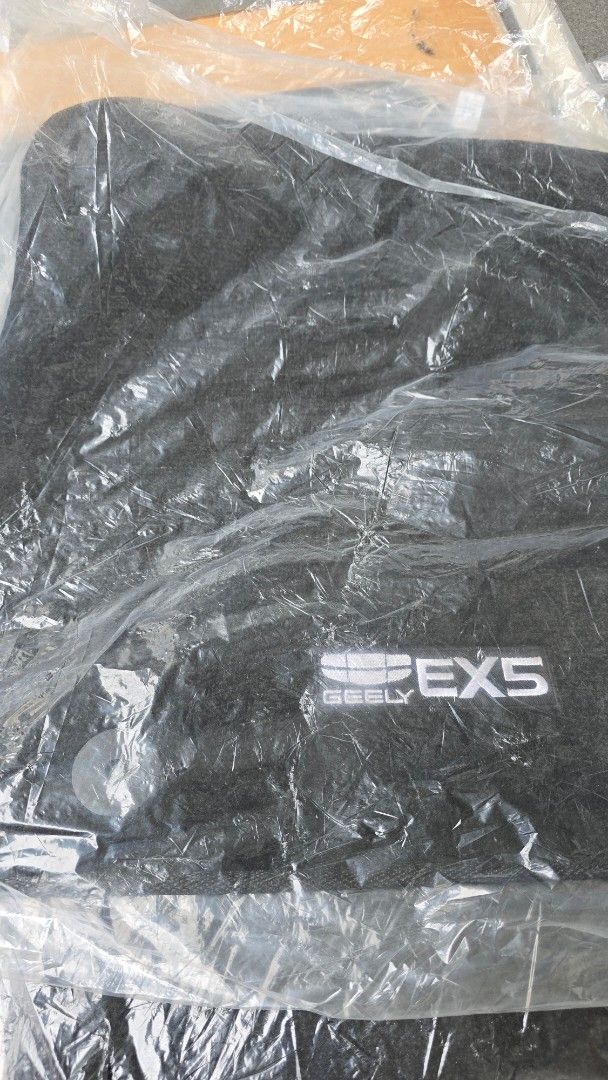 Geely EX5/Galaxy E5 Car Floor Mats (Category: Upholstery, Seatcovers and Other Interior Parts and Accessories) located in Pasig City. Submitted by acerrace (Listing ID 1429173244, Image 2). Description: New and unused. With non-slip backing and attaches to the car mat retainer clip. You can use this as your spare mat when you wash your used set. Set of car floor mats for Galaxy E5/EX5. The mats are black and appear to be new, still in their origi