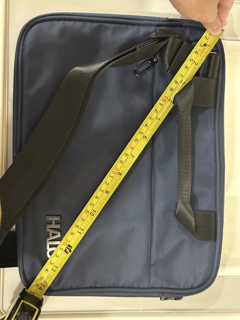 Halo Laptop Bag - Navy Blue (Category: Laptop Bags & Sleeves) located in Mandaluyong City. Submitted by ourcscloset (Listing ID 1424179404, Image 2). Description: - Navy blue laptop bag - Features the "HALO" logo - Includes a handle and front zipper - Small front pocket - Made of durable, possibly water-resistant material - Ideal size for laptops and essentials Foam Tablet/ Laptop case with zipper pocket in front, used to fit 10inch Ipad with key