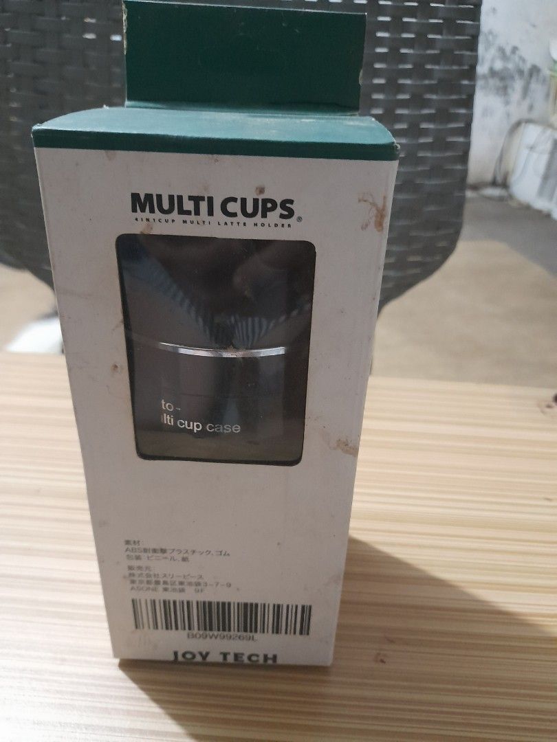 Joy Tech Multi Cups Auto Cup Case (Category: Coffee & Tea Tableware) located in Bocaue. Submitted by marajapansurplus (Listing ID 1429168073, Image 1). Description: Multi Cups auto cup case from Joy Tech. The cup case is black with a brown base and a silver accent. The box indicates it is a cup case. It has a multi-cup design..