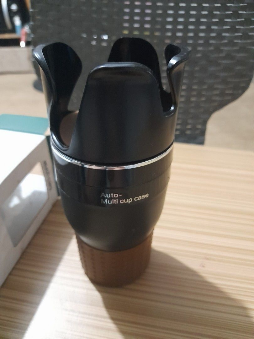 Joy Tech Multi Cups Auto Cup Case (Category: Coffee & Tea Tableware) located in Bocaue. Submitted by marajapansurplus (Listing ID 1429168073, Image 2). Description: Multi Cups auto cup case from Joy Tech. The cup case is black with a brown base and a silver accent. The box indicates it is a cup case. It has a multi-cup design..