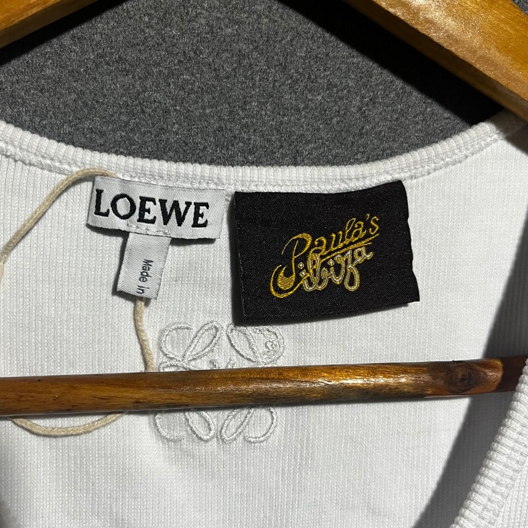 Loewe Paula's Ibiza Tank Top (Category: Luxury Apparel) located in Bacolod City. Submitted by boujee.wardrobes (Listing ID 1429319254, Image 2). Description: White tank top from Loewe Paula's Ibiza collection. Features a graphic print on the front and the Loewe logo. Made in Portugal. Size M. Made of 95% cotton and 5% elastane. The tank top has a ribbed texture. 21L 14W.