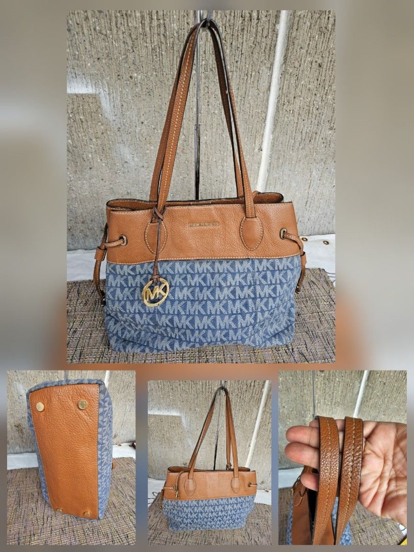 Michael Kors Denim Tote Bag (Category: Luxury Bags & Wallets) located in Manila. Submitted by onlinesmartshopping12 (Listing ID 1429291137, Image 1). Description: Stylish Michael Kors tote bag featuring a brown leather top and handles, paired with a blue MK-patterned fabric body. The bag has a gold-tone MK logo and drawstring details on the sides. The bag has a classic design with a modern twist..