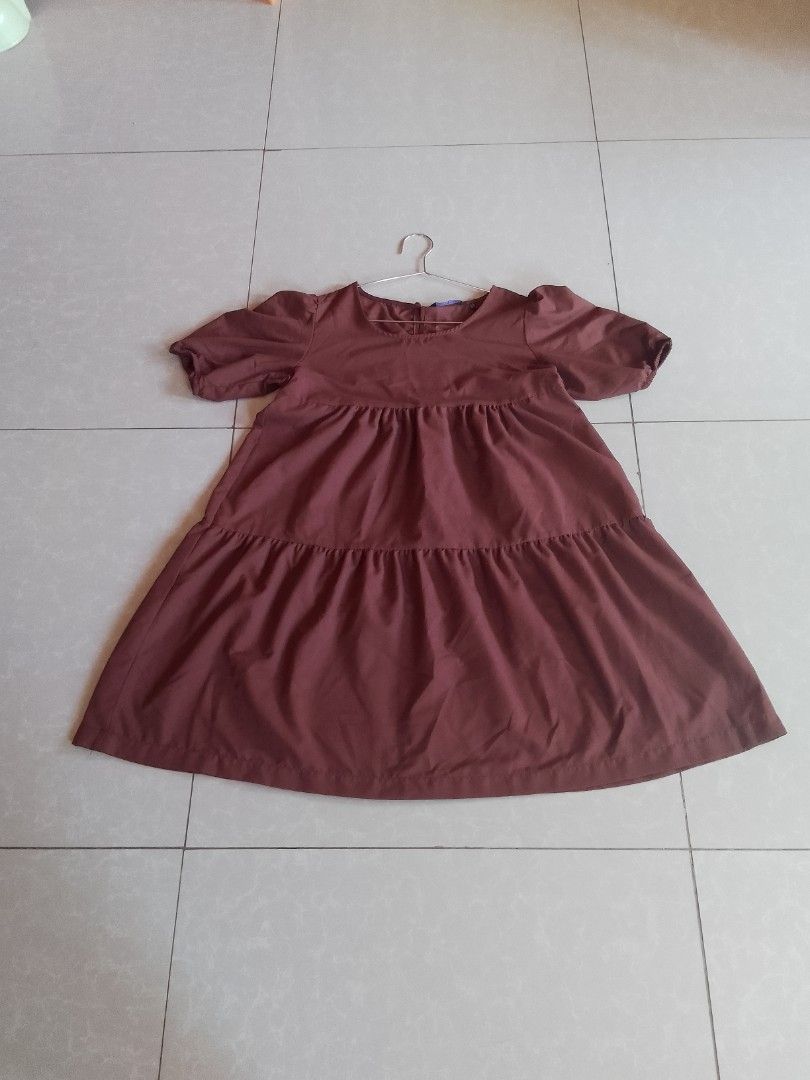 Penshoppe Tiered Dress (Category: Dresses) located in Davao. Submitted by declutter-ecothings (Listing ID 1429182795, Image 2). Description: Brown tiered dress from Penshoppe. Features short sleeves and a round neckline. Made of 100% cotton. Size S. Made in the Philippines. The dress has a relaxed fit and a button detail. In puff sleeve. .
