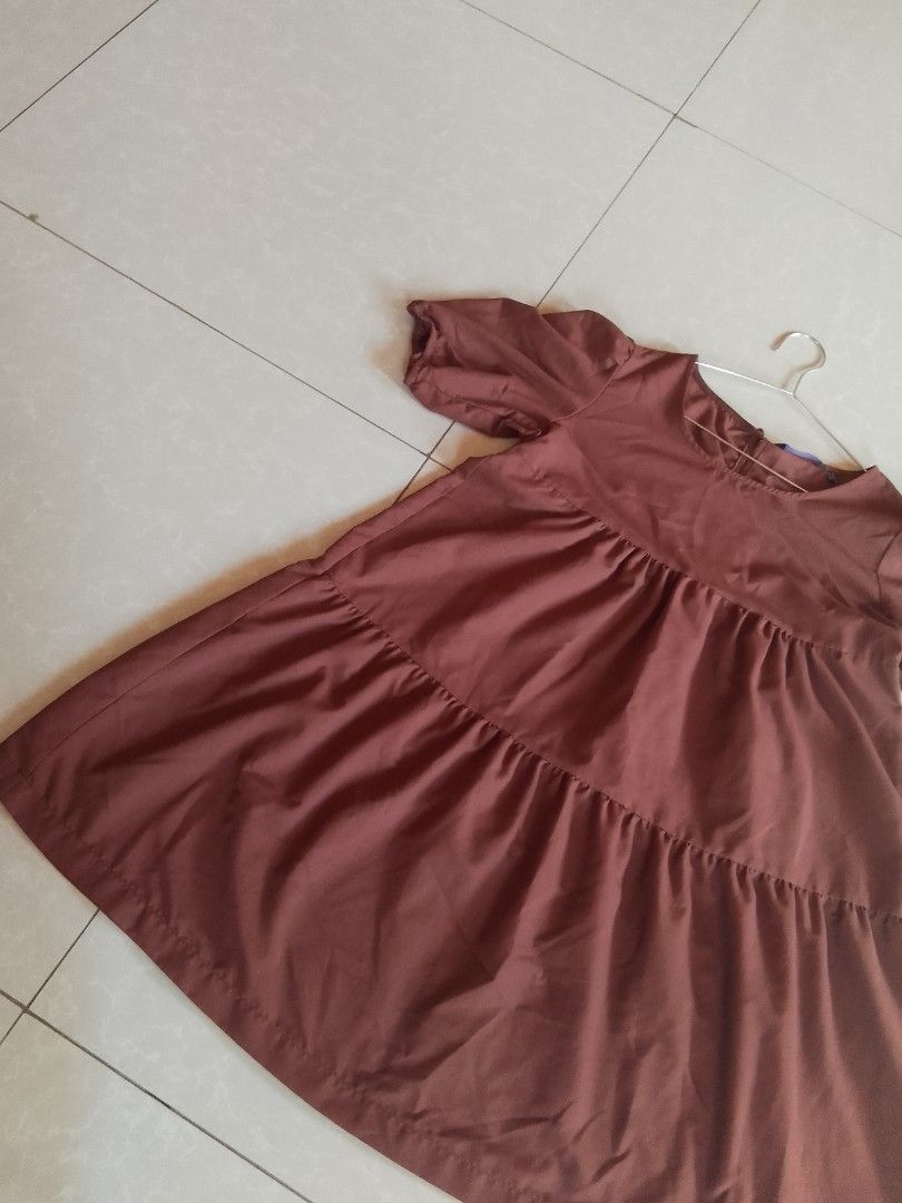 Penshoppe Tiered Dress (Category: Dresses) located in Davao. Submitted by declutter-ecothings (Listing ID 1429182795, Image 3). Description: Brown tiered dress from Penshoppe. Features short sleeves and a round neckline. Made of 100% cotton. Size S. Made in the Philippines. The dress has a relaxed fit and a button detail. In puff sleeve. .