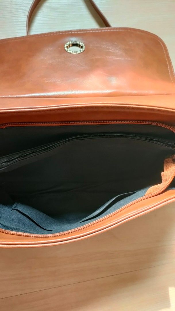 preloved Vintage Brown Handbag with Shoulder Strap (Category: Shoulder Bags) located in Mandaluyong City. Submitted by itscris28 (Listing ID 1429237622, Image 2). Description: - Classic brown handbag with a top handle and a detachable shoulder strap - Features a flap closure with a decorative metal clasp - The interior has multiple compartments, including a zippered pocket - It has a vintage aesthetic style. - for casual or office days #vintageba