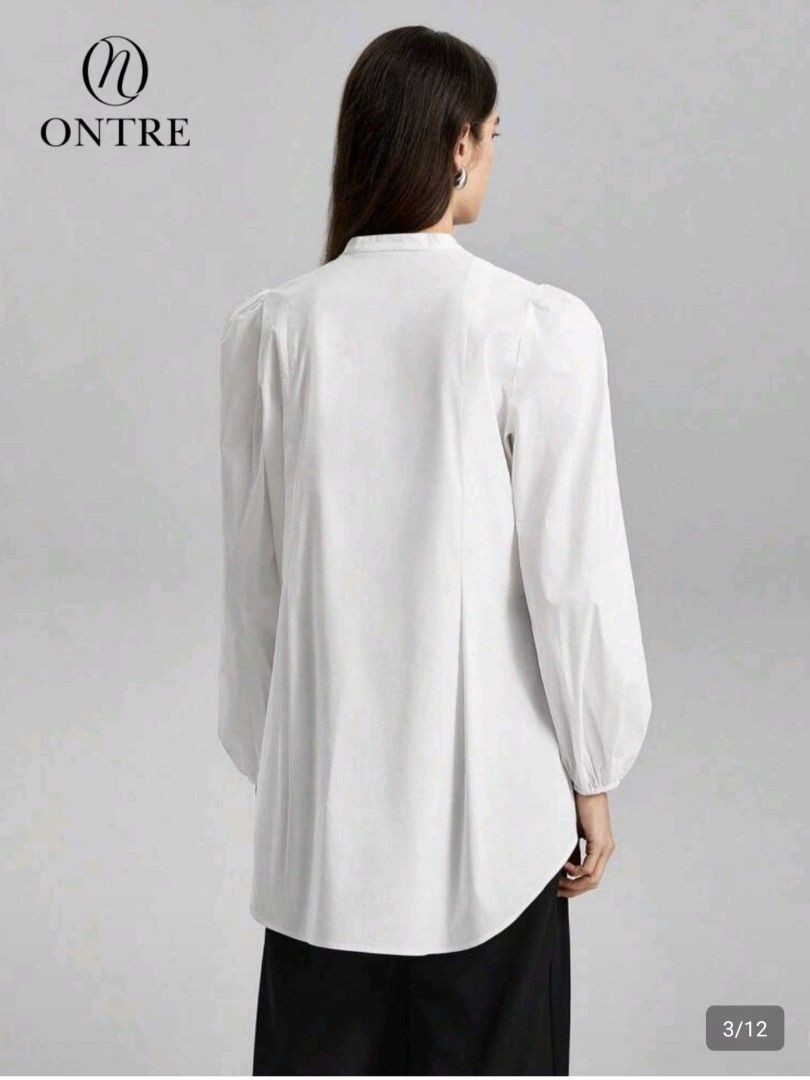 SHEIN Blouse with Tie Front (Category: Blouses) located in Las Pinas. Submitted by mgr29 (Listing ID 1429176706, Image 3). Description: LOOSE CAN FIT SMALL - SEMI LARGE White blouse from SHEIN with a tie-front design. Features long sleeves with puff shoulders. The blouse has a mandarin collar and a relaxed fit. The tag is still attached. Perfect for a casual yet stylish look..