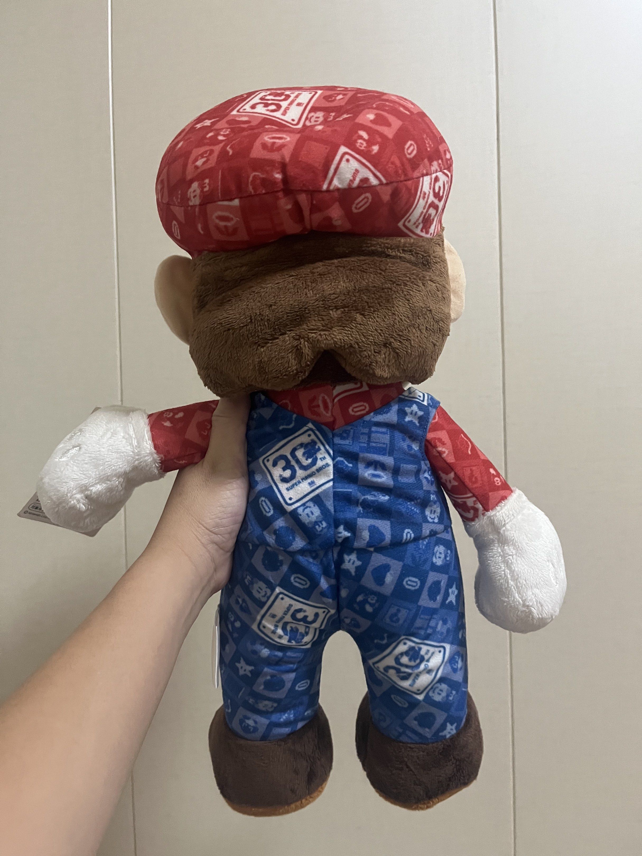 Super Mario 30th Anniversary Plush Toy (Category: Plushies & Soft Toys) located in Las Pinas. Submitted by stuffhaven (Listing ID 1429327691, Image 3). Description: Location : Las Piñas Pick up or lalamove Jnt (Wednesday and Saturday only) -Super Mario 30th anniversary. -It features Mario in his 30th Anniversary outfit including a red cap with the 'M' logo. -With pen mark on face (kindly check picture) -The plush has a tag attached. It would be a