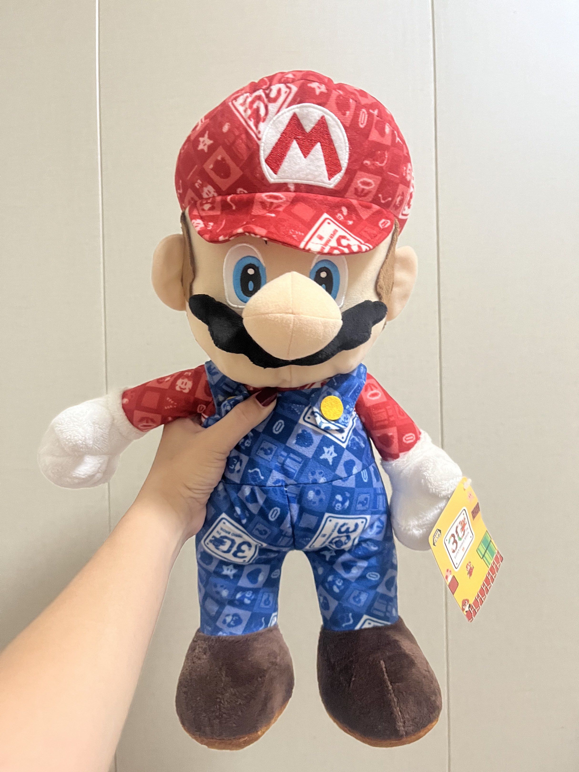 Super Mario 30th Anniversary Plush Toy (Category: Plushies & Soft Toys) located in Las Pinas. Submitted by stuffhaven (Listing ID 1429327691, Image 1). Description: Location : Las Piñas Pick up or lalamove Jnt (Wednesday and Saturday only) -Super Mario 30th anniversary. -It features Mario in his 30th Anniversary outfit including a red cap with the 'M' logo. -With pen mark on face (kindly check picture) -The plush has a tag attached. It would be a