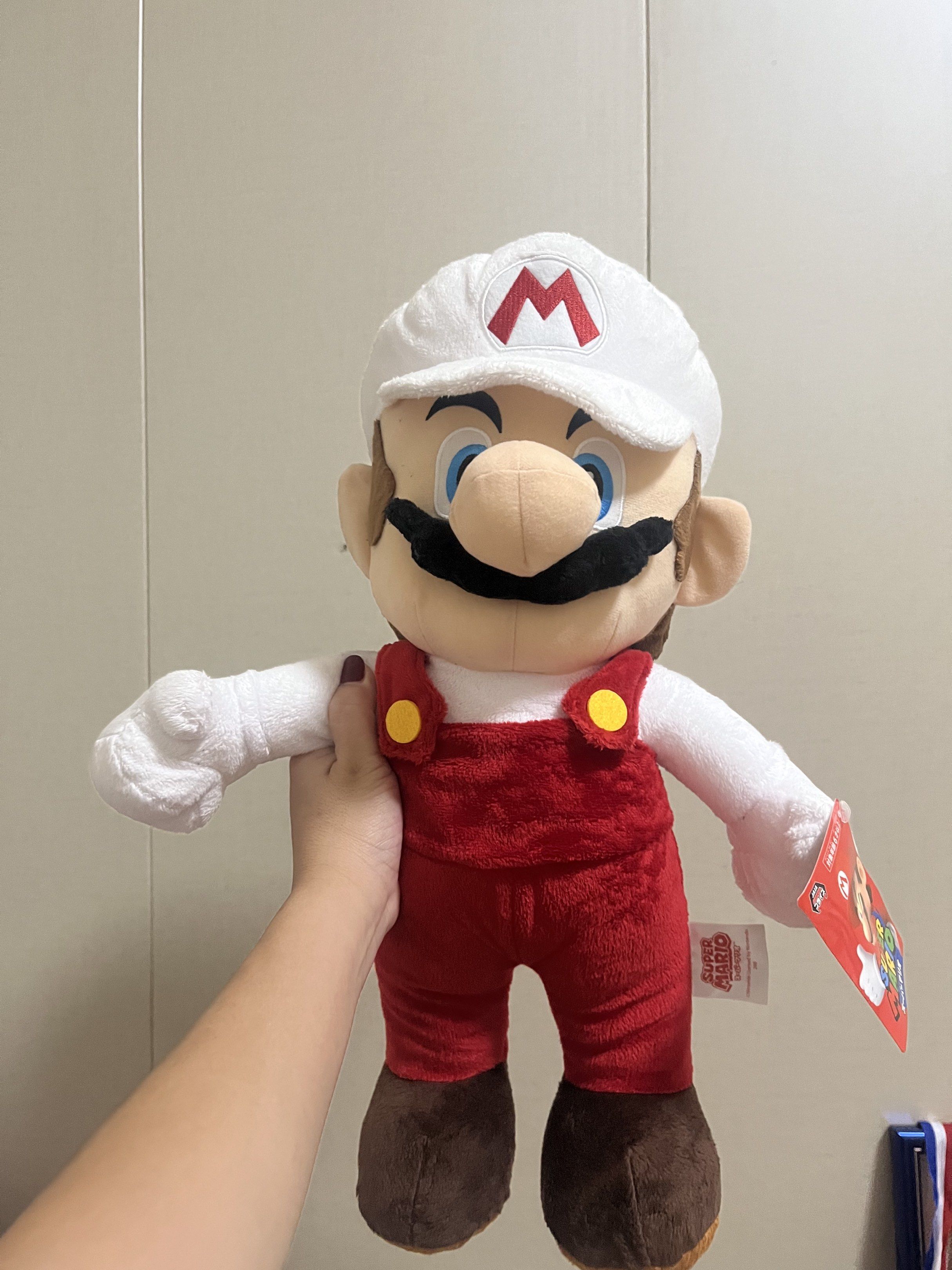 Super Mario Fire Mario Plush Toy (Category: Plushies & Soft Toys) located in Las Pinas. Submitted by stuffhaven (Listing ID 1429327746, Image 1). Description: Location : Las Piñas Pick up or lalamove Jnt (Wednesday and Saturday only) -Super Mario plush toy features Fire Mario in his iconic outfit. -It has a white cap with the 'M' logo, a red jumpsuit, and brown shoes. The toy has a tag attached. It is licensed by Nintendo..