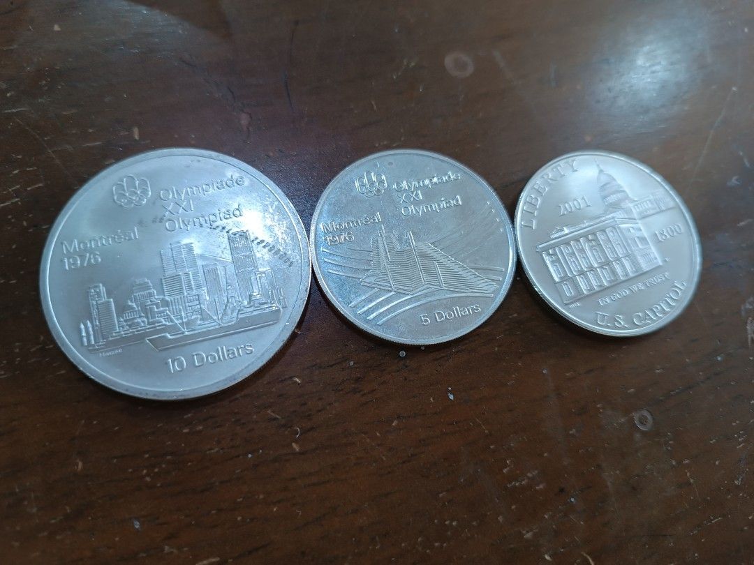 Take all Canadian and US Silver Coins (Category: Currency) located in Quezon City. Submitted by gracechav596 (Listing ID 1429185929, Image 2). Description: Take all 3 coins Collection of silver coins featuring Queen Elizabeth II and various designs. Includes a 10 Dollars coin from the 1976 Montreal Olympics, a 5 Dollars coin, and a US One Dollar coin..