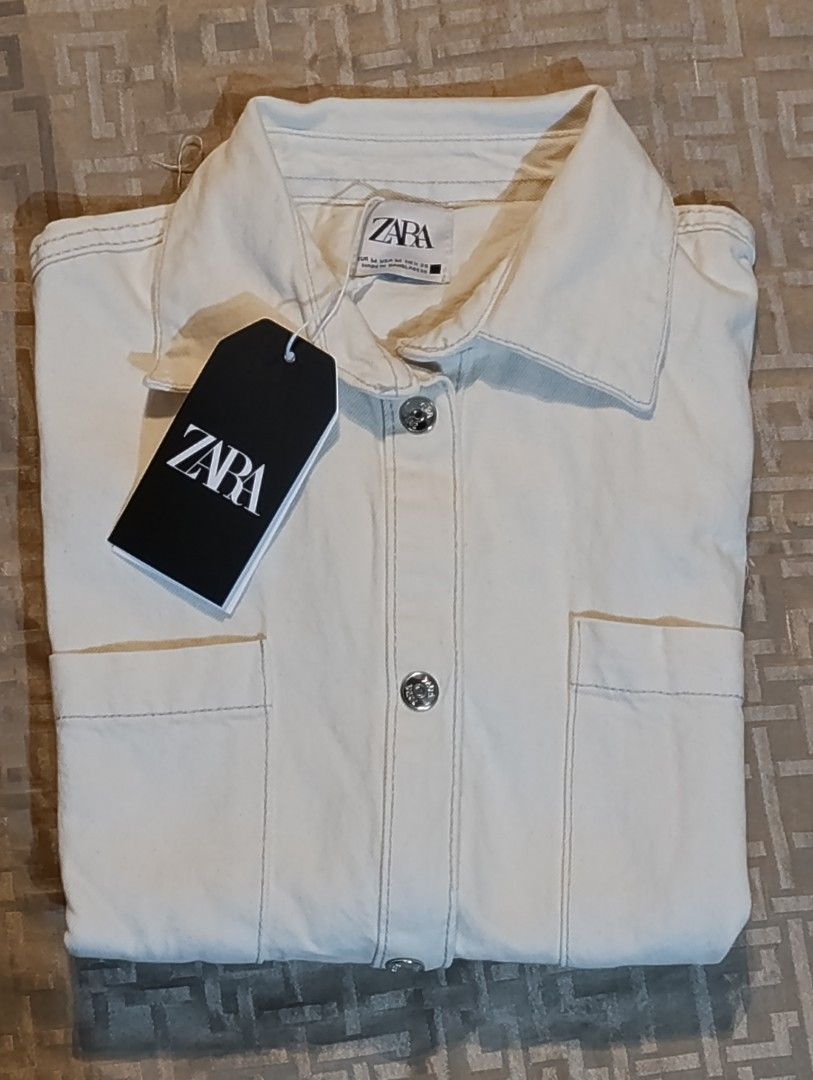 Zara Cropped Denim Shirt (Category: Shirts) located in Manila. Submitted by yunicool (Listing ID 1429229147, Image 2). Description: Zara Cropped Polo / Light Blazer – Brand New with Tag! ✨ Details: Brand new with tag 🎨 Color: Off-white / cream (clean, classy, madaling i-style) 👕 Cropped polo / button-down style 💼 Pwede gawing light blazer / outerwear 📦 With front pockets (functional + stylish) 💯 Soft and breathable fabric 👌 Perfect for: Cas
