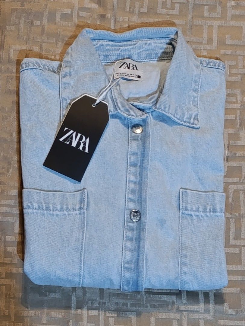 Zara Denim Cropped Shirt (Category: Shirts) located in Manila. Submitted by yunicool (Listing ID 1429228408, Image 2). Description: Zara Denim Cropped Polo – Brand New with Tag! ✨ Details: Brand new with tag 🎨 Color: Light denim blue (fresh at madaling i-style) 👕 Cropped polo / button-down style 💼 Pwede gawing light blazer / outerwear 📦 May front pockets (functional + stylish) 💯 Soft yet structured denim fabric 👌 Perfect for: Casual outfits