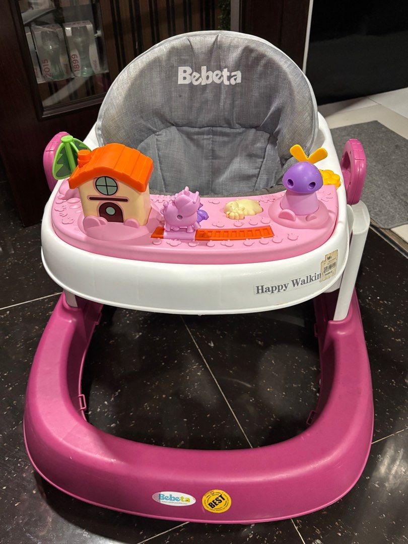 Bebeta Happy Walking Baby Walker (Category: Infant Playtime) located in Quezon City. Submitted by things.matter (Listing ID 1429395386, Image 1). Description: - Bebeta Happy Walking baby walker - Pink and white design - Interactive toys: house, animals, windmill - Gray seat - Sturdy base and wheels - Easy movement - Original price tag included.