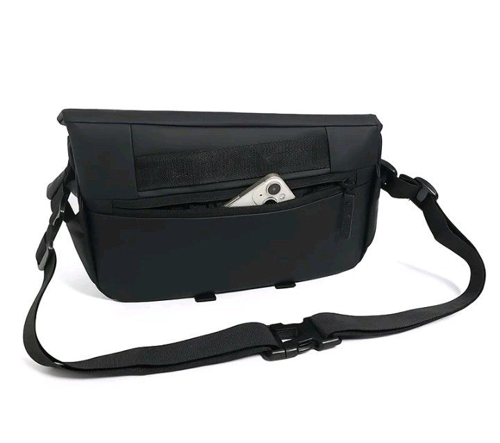 Black Sling / Messenger Bag Bag with Adjustable Strap (Category: Luxury Bags & Wallets) located in Makati City. Submitted by micmic804 (Listing ID 1429455416, Image 1). Description: Black messenger bag features a front pocket and an adjustable strap. It has a flap closure and a buckle for securing the strap. It's a practical choice for carrying essentials. The bag has a sleek, minimalist design..