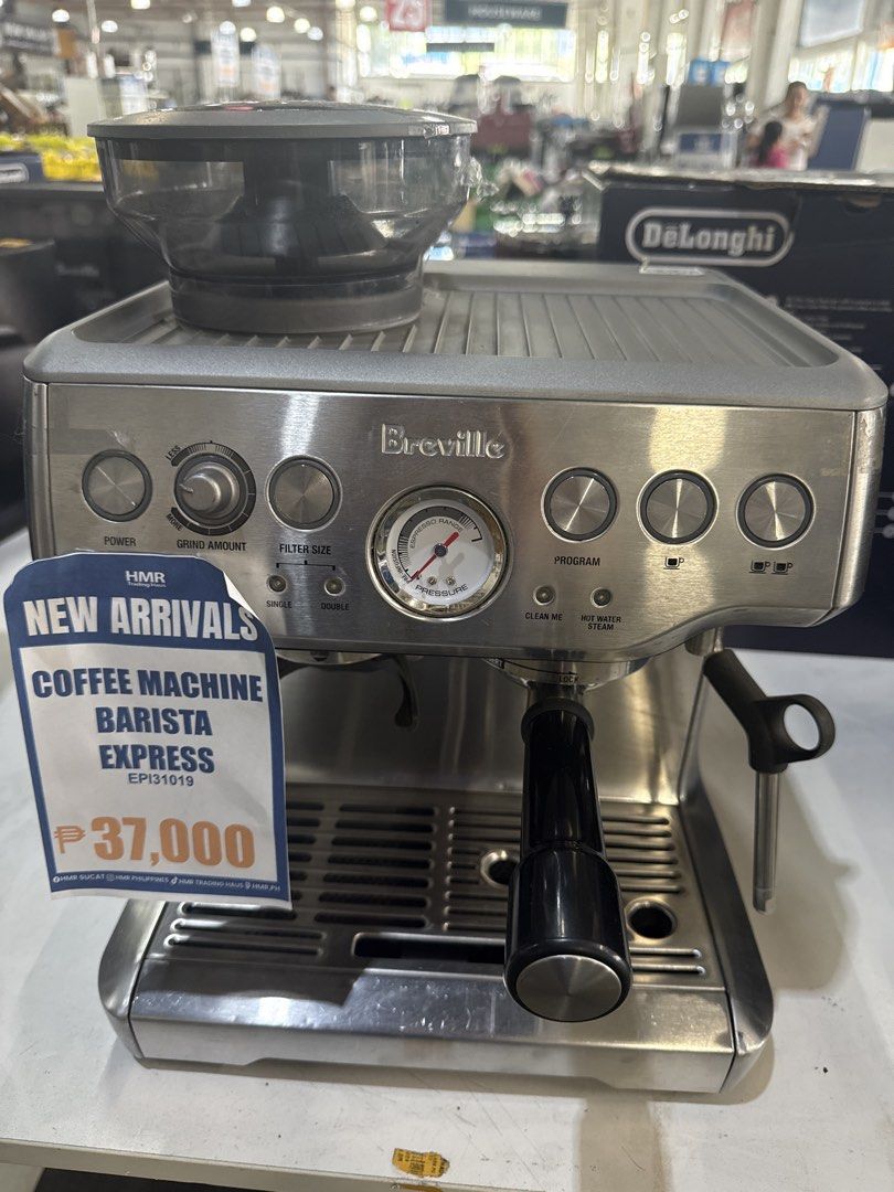 Breville Barista Express Coffee Machine (Category: Coffee Machines & Makers) located in Manila. Submitted by joylontok16 (Listing ID 1429359766, Image 1). Description: Breville Barista Express coffee machine is a stainless steel espresso machine. It features a built-in grinder, steam wand, and various control dials for power, grind amount, filter size, and program settings. The machine has a pressure gauge and a drip tray. The price tag indicates