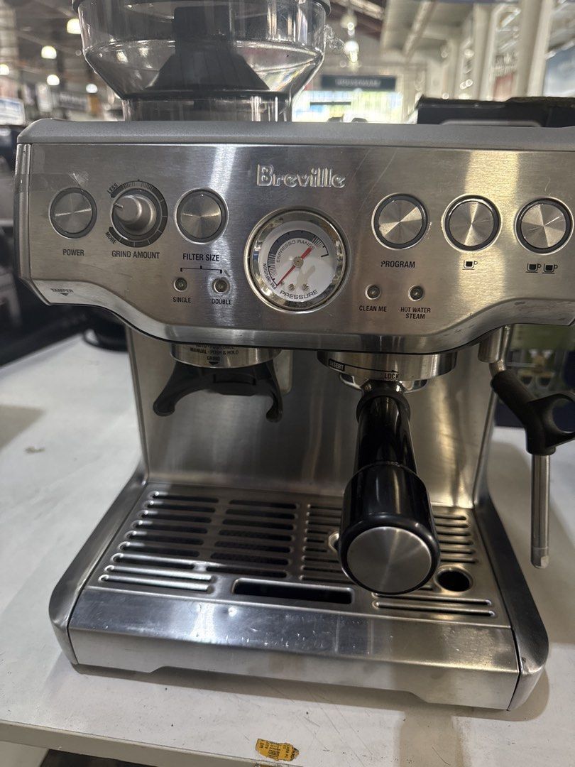 Breville Barista Express Coffee Machine (Category: Coffee Machines & Makers) located in Manila. Submitted by joylontok16 (Listing ID 1429359766, Image 2). Description: Breville Barista Express coffee machine is a stainless steel espresso machine. It features a built-in grinder, steam wand, and various control dials for power, grind amount, filter size, and program settings. The machine has a pressure gauge and a drip tray. The price tag indicates