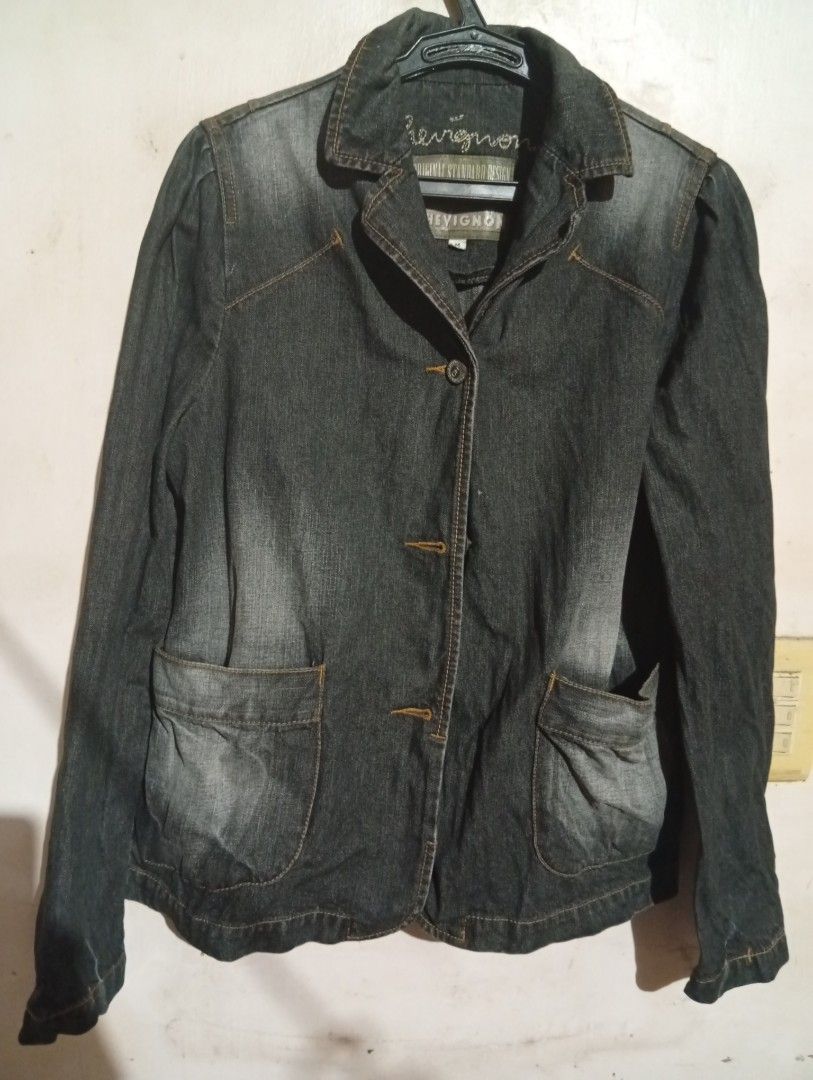 Chevignon Denim Jacket - Medium (Category: Coats, Jackets and Outerwear) located in Las Pinas. Submitted by magda09 (Listing ID 1429421491, Image 1). Description: Stylish denim jacket from Chevignon. Features a classic design with button closure and two front pockets. The jacket has a medium size. The back of the jacket has a tailored design. The jacket is a dark denim color. The brand name is embroidered on the collar..