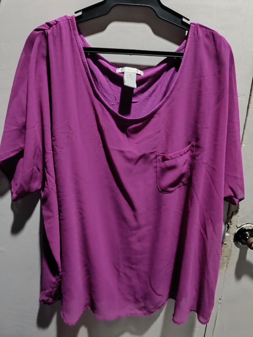 Design History Purple Blouse 1X (Category: Blouses) located in Subic. Submitted by yssacollection (Listing ID 1429494971, Image 1). Description: Purple blouse from Design History. Features a scoop neck, short sleeves, and a single pocket on the chest. The size is 1X. Made of polyester. The blouse is a vibrant purple color. Perfect for casual wear..