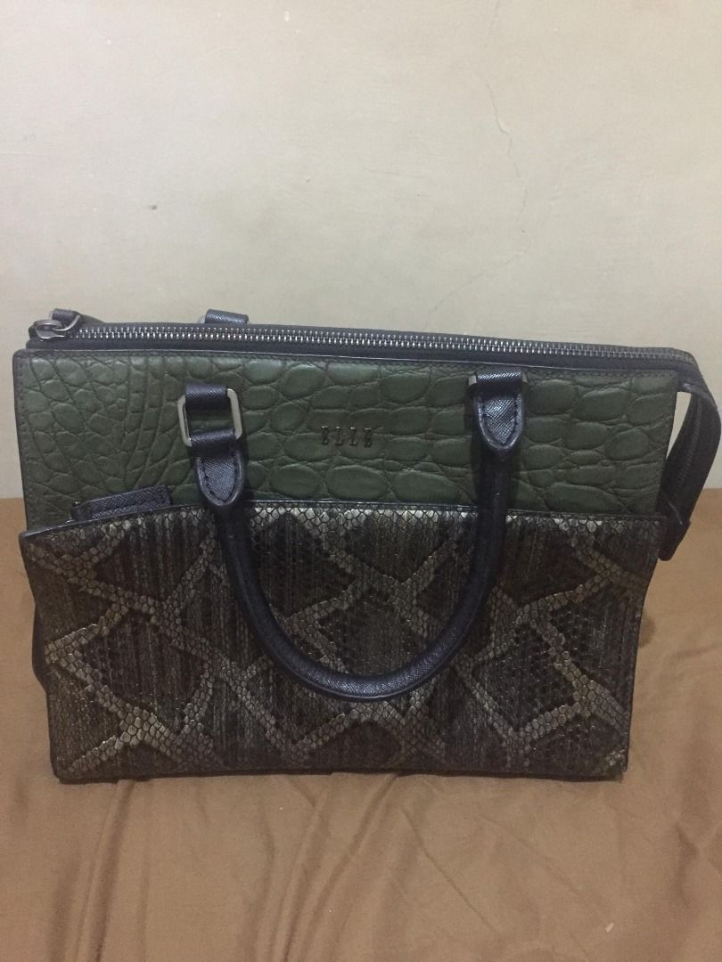 Elle Handbag with Snake Skin Design (Category: Luxury Bags & Wallets) located in Pila. Submitted by dominguezd14376 (Listing ID 1429459538, Image 1). Description: RFS: HINDI NAGAMIT NAKATAMBAK LANG KAYA MAG BABAWAS, GOOD CONDITION PA ANG ZIPPER AND WITH TOP HANDLE BAG SYA PWEDE DIN MAG STRAP. Elle handbag with a unique design. Features a combination of green crocodile-embossed leather and a snake skin pattern. The bag has a top handle and a zippe