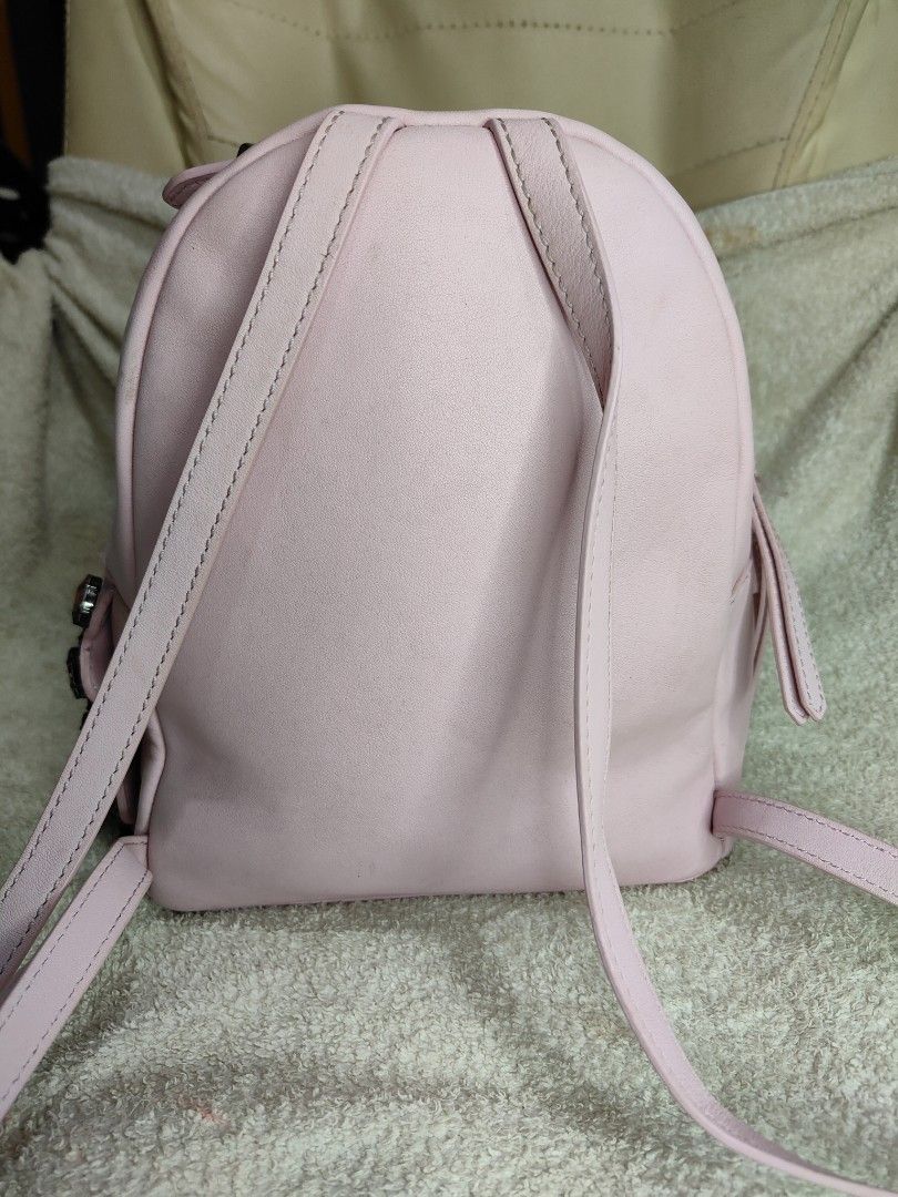 Fendi Pink Leather Backpack (Category: Luxury Bags & Wallets) located in Cebu City. Submitted by cherreymie70208 (Listing ID 1429464018, Image 3). Description: Pink leather backpack by Fendi. Features a top handle, adjustable shoulder straps, and a front zip pocket. The interior is lined with black fabric and includes a Fendi label. Adorned with red jewel embellishments on the side. The zipper has the Fendi logo. Made in Italy..