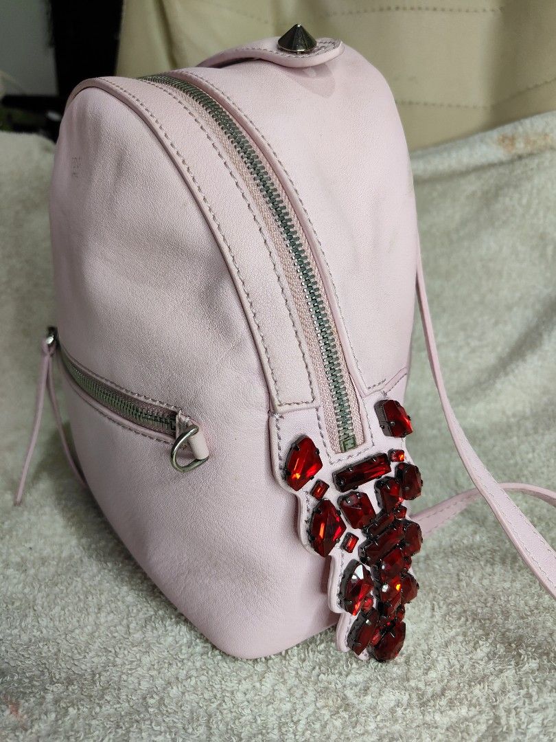 Fendi Pink Leather Backpack (Category: Luxury Bags & Wallets) located in Cebu City. Submitted by cherreymie70208 (Listing ID 1429464018, Image 2). Description: Pink leather backpack by Fendi. Features a top handle, adjustable shoulder straps, and a front zip pocket. The interior is lined with black fabric and includes a Fendi label. Adorned with red jewel embellishments on the side. The zipper has the Fendi logo. Made in Italy..