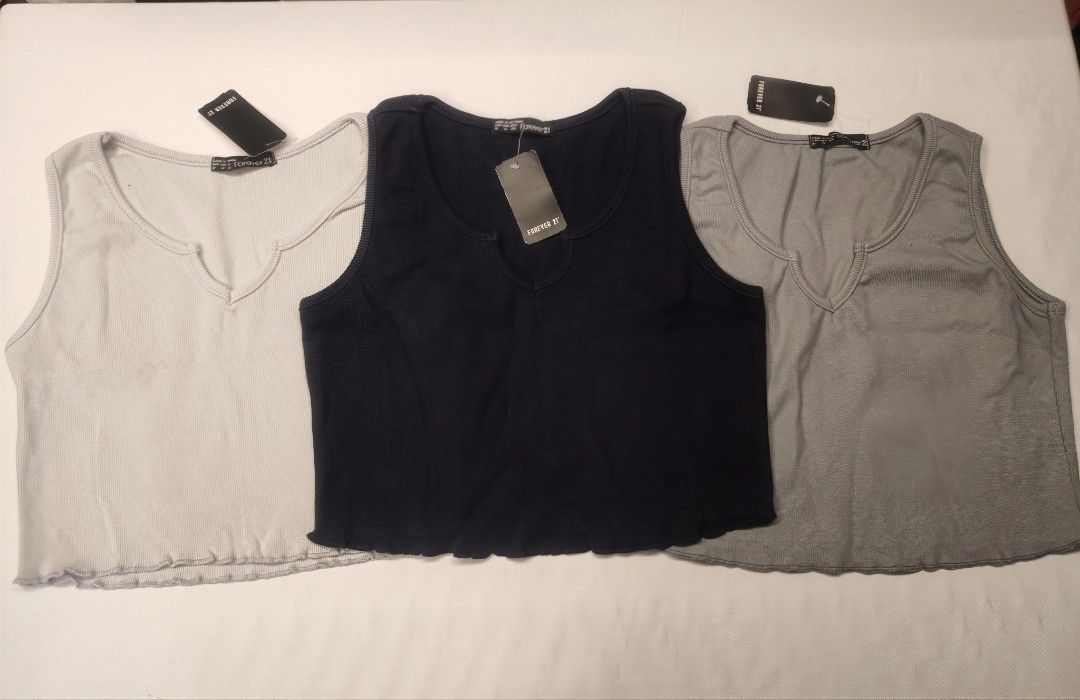 Forever 21 Crop Top (Category: Others Tops) located in Quezon City. Submitted by rowem (Listing ID 1429469242, Image 1). Description: Stylish crop tops from Forever 21. Available in three colors: light gray, black, and gray. Features a flattering V-neck design and a scalloped hem. Perfect for pairing with high-waisted bottoms. These tops are brand new with tags..
