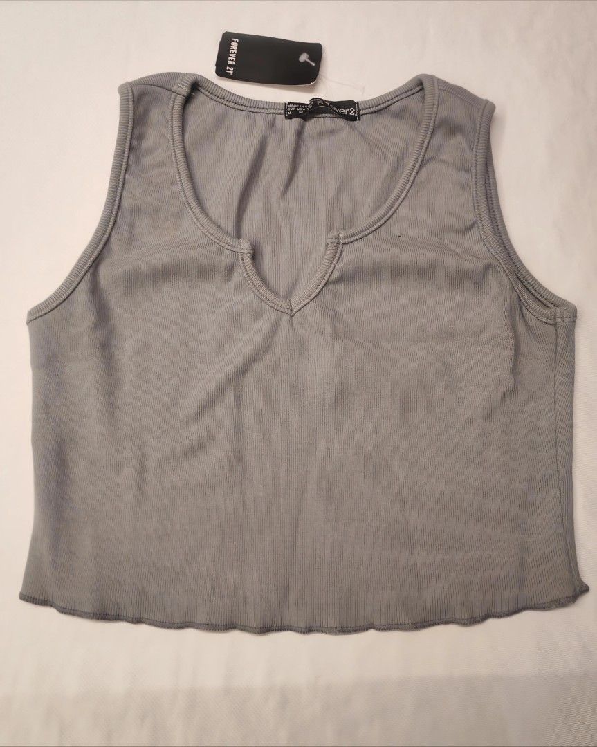 Forever 21 Crop Top (Category: Others Tops) located in Quezon City. Submitted by rowem (Listing ID 1429469242, Image 3). Description: Stylish crop tops from Forever 21. Available in three colors: light gray, black, and gray. Features a flattering V-neck design and a scalloped hem. Perfect for pairing with high-waisted bottoms. These tops are brand new with tags..