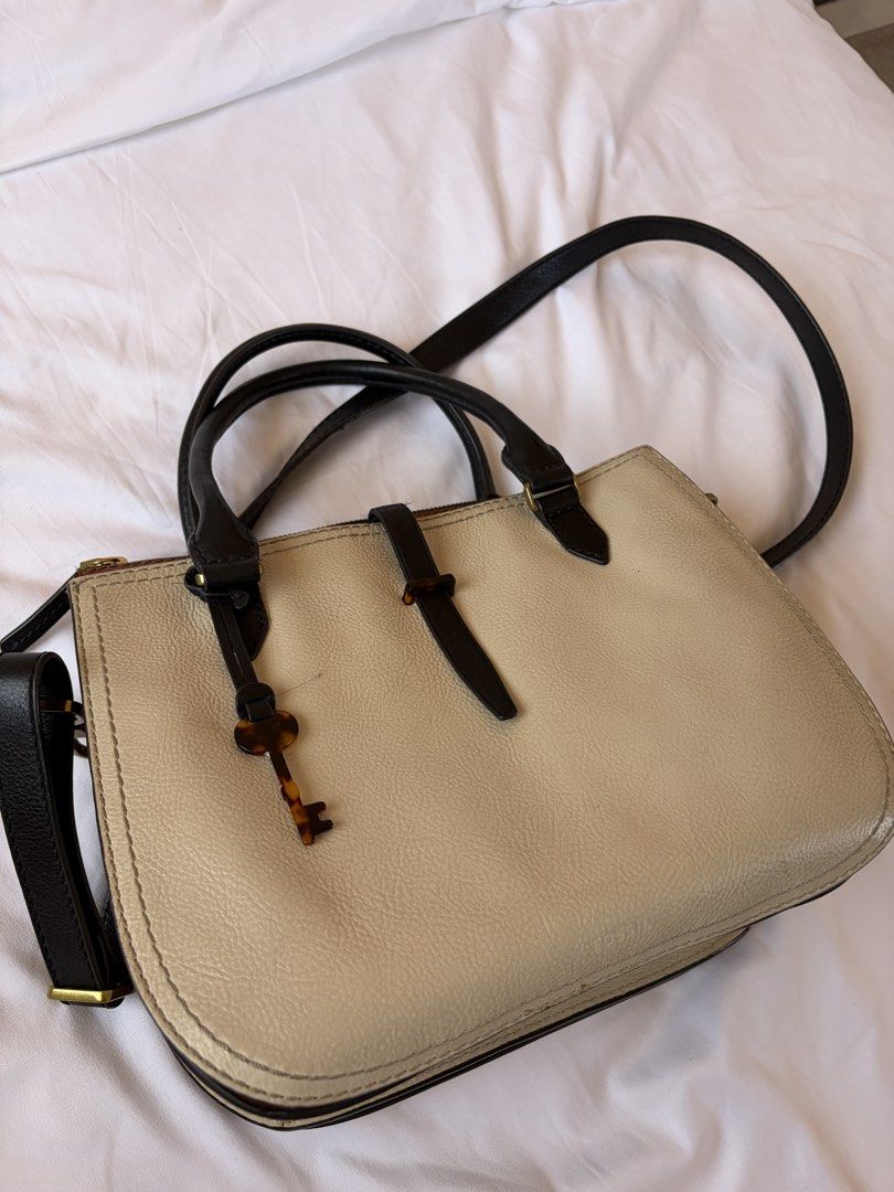 Fossil Satchel Handbag (Category: Luxury Bags & Wallets) located in Las Pinas. Submitted by ktrnblyt (Listing ID 1429351450, Image 1). Description: Selling Authentic Fossil Ryder Leather Satchel Used but not abused Color: Light Taupe Measurements: 9’’L x 4.25’’W x 7’’H - Exterior Material: Leather - Exterior Details: 2 Gusseted Slide Pockets - Interior Material: 100% Polyester - Interior Details: 1 Zipper Pocket, 2 Slide Pockets - Closure Type: Z