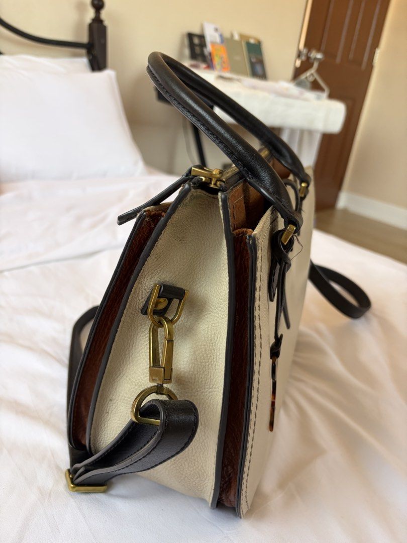 Fossil Satchel Handbag (Category: Luxury Bags & Wallets) located in Las Pinas. Submitted by ktrnblyt (Listing ID 1429351450, Image 2). Description: Selling Authentic Fossil Ryder Leather Satchel Used but not abused Color: Light Taupe Measurements: 9’’L x 4.25’’W x 7’’H - Exterior Material: Leather - Exterior Details: 2 Gusseted Slide Pockets - Interior Material: 100% Polyester - Interior Details: 1 Zipper Pocket, 2 Slide Pockets - Closure Type: Z